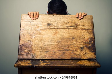 Man looking inside old school desk