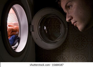 Man Looking Inside The Washing Machine