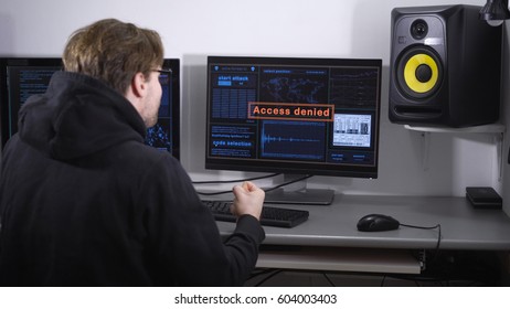 The man, looking like a hacker, failed its mission of breaking the secret data of another country. was highlighted terrible inscription on a computer monitor