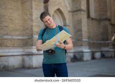 Man looking lost and uncertain while trying to understand a paper map in a city