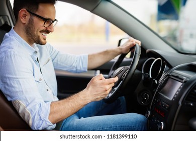 Man looking at mobile phone while driving