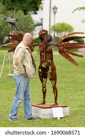 Man Looking At A Modern Sculpture Set At A City Park. May 19, 2015. Kiev, Ukraine