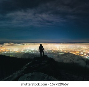 Man Looking Night City From High Mountain