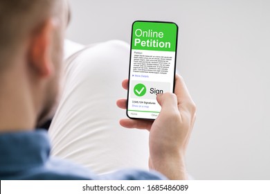 Man Looking At Online Petition Form On Smartphone