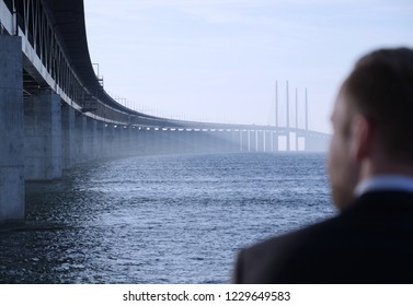 Man Looking At The Oresund Bridge