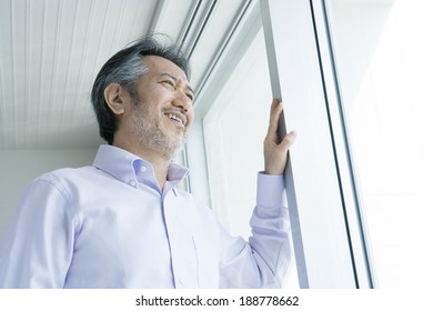 man looking out window