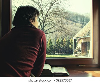 Man Looking out of Window