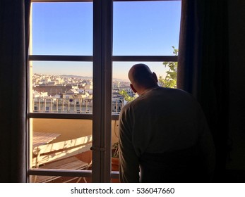 Man looking out window