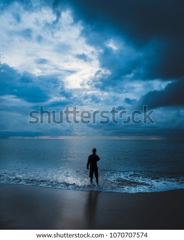 Similar – a woman looks at the sea. rear view, blurred