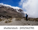 Man looking over the summit of Mt Kilimanjaro