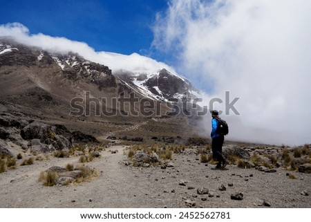 Man looking over the summit of Mt Kilimanjaro