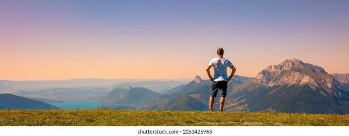 Man looking at panoramic view of sunset mountain
