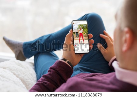Man looking at photo sharing app on mobile phone