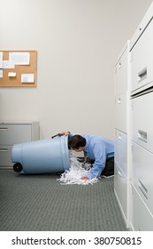 Man Looking A Shredded Paper Bin