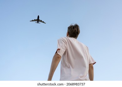 man looking up in the sky and cheer the airplane  - Shutterstock ID 2068983737