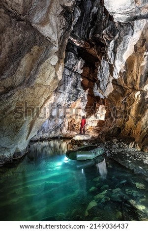 A man looking subterranean lake view. Cave, caving, speleology