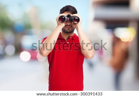 man looking through binoculars
