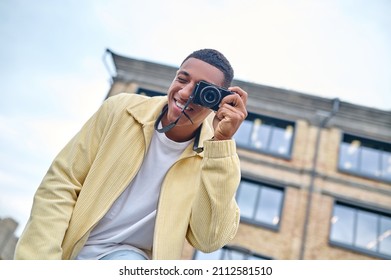 Man Looking Through Camera Lens Outdoors