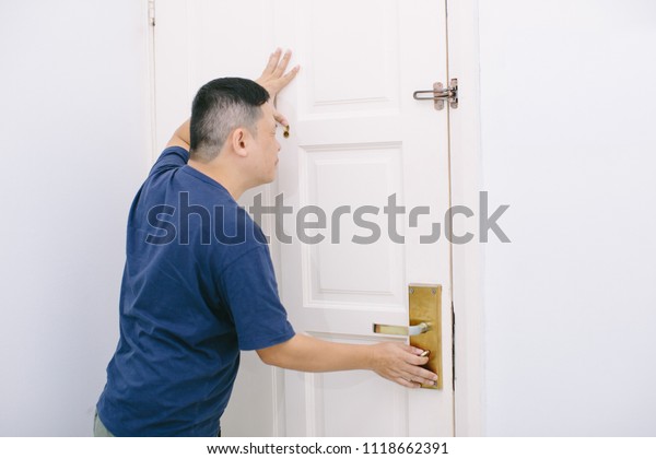 Man Looking Through Door Hole Surprising Stock Photo Edit Now