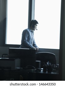 Man looking through window in office