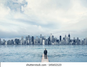man looking at the town on a horizon