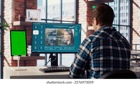 Man looking at tutorial on green screen tablet to learn how to use text to video generative models. Man in home office watching video guide on mockup device about AI program, camera B - Powered by Shutterstock - Get 15% off with code: PIKWIZARD15