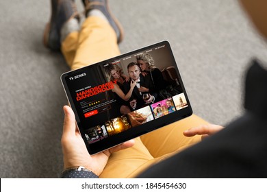 Man Looking TV Series And Movies Via Streaming Service On His Digital Tablet