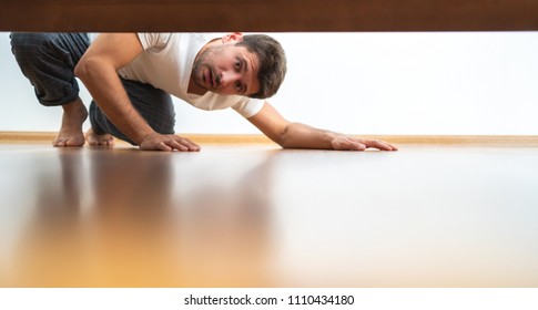 The Man Looking Under The Bed