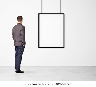 Man Looking At White Poster 