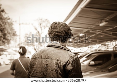 Man looking woman in car park, Criminal man, Crime concept,Vintage sepia