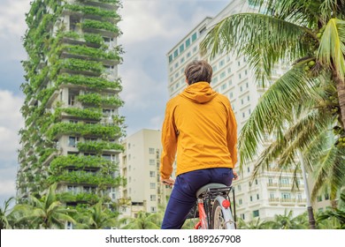 Man Looks At Eco Architecture. Green Cafe With Hydroponic Plants On The Facade. Ecology And Green Living In City, Urban Environment Concept. Modern Building Covered Green Plant