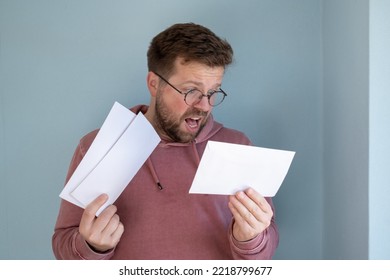 Man Looks At Gas Bills, He Is Shocked By Rising Prices. Concept Of The Energy Crisis.