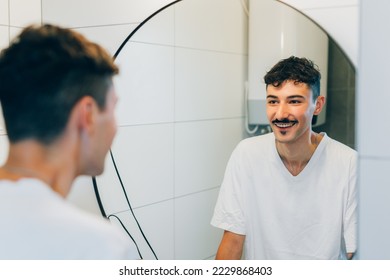 Man looks at himself in the mirror - Powered by Shutterstock