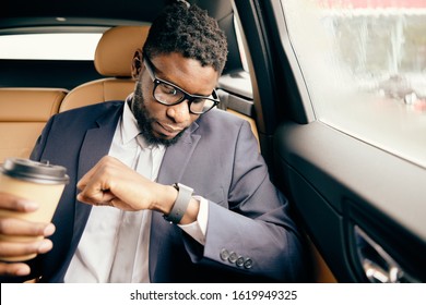 Man Looks At His Apple Watch While Holding Coffee Cup.