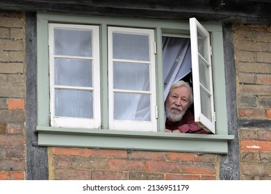 A Man Looks Out Of A House Window During The Traditional Boxing Day Hunt On December 26, 2013 In Chippenham, UK. Fox Hunting Is Technically Outlawed In The UK With Meets Following Scented Trails.