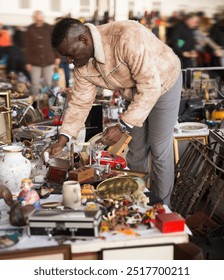 Man looks at second-hand items at