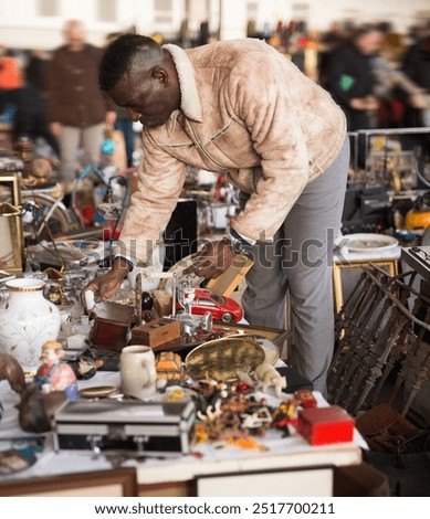 Man looks at second-hand items at