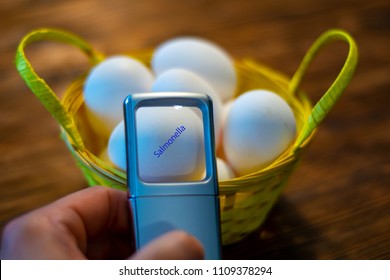 A Man Looks At Some Eggs In A Basket And Discovers An Egg With Salmonella