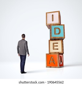 Man looks at word Idea made of colored cubes - Shutterstock ID 190645562