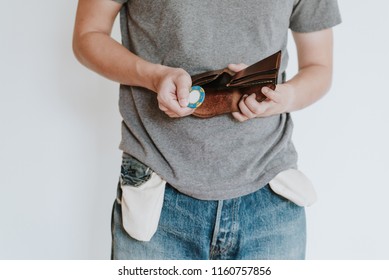 Man Loose All The Money To Casino. In His Leather Wallet Is Empty No Cash Only Have One Chip Left. Concept Of Unemployed And Having Bankruptcy Gambling Addicted No Money, Isolated On White Background.