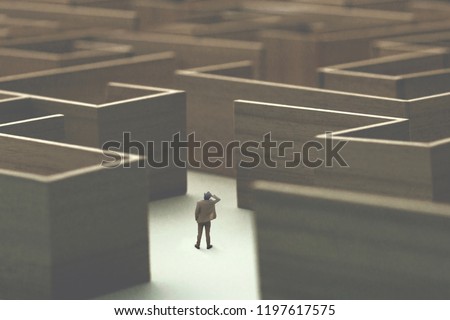 man lost in a complex maze, surreal concept