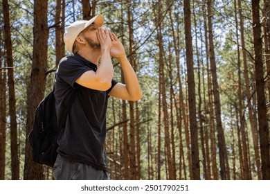 Man lost in the forest. Man looking at phone. No network on phone. Navigation. Emergency in the forest. Man calling for help - Powered by Shutterstock