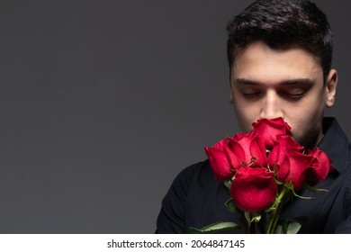 Man In Love Wearing Dark Blouse, Smelling Roses, Space For Text On The Side.