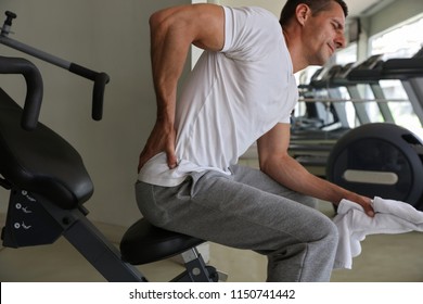 Man With Low Back Pain In Gym. Sports Exercising Injury