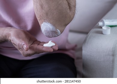 Man Lubricate His Elbow With Ointment For Rheumatism