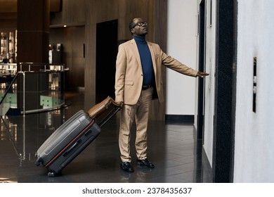 Man with luggage waiting for the elevator