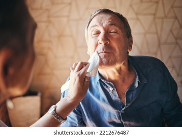 Man, Lunch And Woman Wipe Mouth In Retirement While Together In Home For Breakfast, Dinner Or Food. Elderly, Couple And Care With Lady Cleaning Husband Face During Meal In House, Cafe Or Restaurant