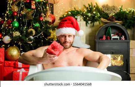 Man Lying In Bathtub Relax With Gift Box. Sexy Macho Relax In Bathtub. Spa And Wellness. Pampering Myself. Holidays Relax. Christmas Tour Concept. Enjoy New Years Eve Celebrations Book Stay Hotel.