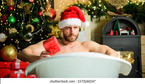 Man Lying In Bathtub Relax With Gift Box. Sexy Macho Relax In Bathtub. Spa And Wellness. Enjoy New Years Eve Celebrations Book Stay Hotel. Pampering Myself. Holidays Relax. Christmas Tour Concept.