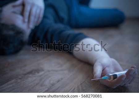 Man lying down on the floor after a drug overdose